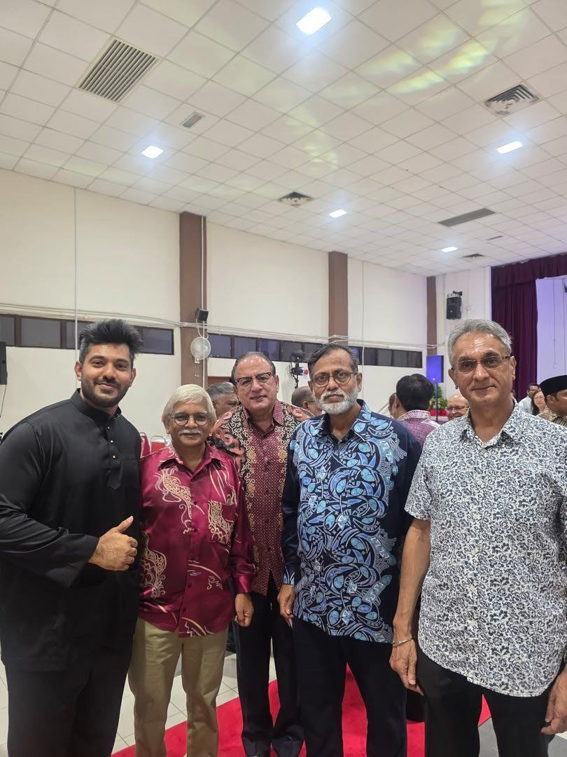 Friends posing with a thumbs up at an event